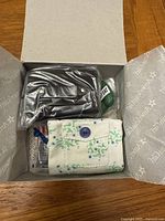 Rebecca's School Set partially unpacked inside original box showing black satchel, cloth pouch, and miniatures