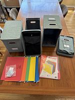 Four folding fabric light green file boxes, four lids, twelve hanging file folders in assorted colors, and one new sealed pack of 15 colored file folders.