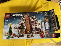 Box front showing LEGO Creator Expert Gingerbread House set 10267, age 12+, 1477 pieces with detailed seasonal design.