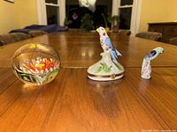 Photo showing all three items on wooden table: paperweight, Limoges trinket box with bird on top, small porcelain bird figurine.