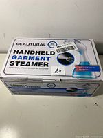 Photo of the product box showing the brand Beautural and product title Handheld Garment Steamer with key features like powerful steam in 30 seconds and safe on all fabrics.