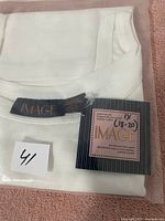 Folded white ladies T-shirt showing Image brand label and size 18-20 tag.
