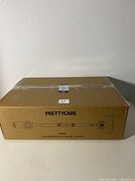 Front view of boxed PrettyCare W400 rechargeable vacuum cleaner showing brand and product image on box.