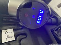 Close-up of digital display and control buttons on massage gun