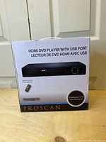 Box front of Proscan HDMI DVD Player PDVD6670 showing product image and labeling HDMI DVD Player with USB port, remote control included.