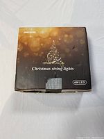 Front view of the box showing the brand JMEXSUSS, product name Christmas string lights, and LED count of 600 lights with festive winter design.