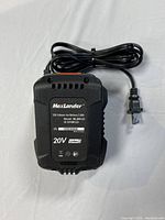 Black Maxlander 20V lithium battery pack with venting and power rating labels, laying on a flat surface.