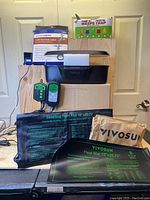 Full view of the entire lot including seedling heat mats, wasp traps, pipe heating cable box, submersible pump, air quality monitor, and iDeer grow light unit on top.