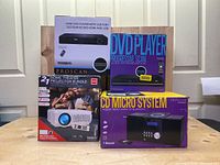 Front view of all items in their boxes including RCA home theater projector, Proscan DVD player, and Proscan CD micro system
