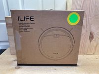Box featuring ILIFE branding and an illustration of the robotic vacuum cleaner.