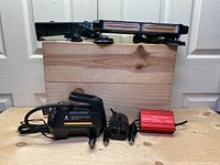 Rear view mirror dashcam, LED plug-in lights, 400W power inverter, vehicle pump, and car multiport USB adapter displayed front view on wooden surface