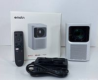 Projector unit, remote control, sealed box and power cable displayed