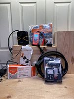 Lot contents showing multiple automotive and electronic car tools including air pump, chargers, scan code reader, and sunshade.