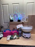 Full set showing cotton candy machine, two balloon pumps, two balloon bags, disco lights and light-up letters.