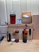 Wide view of all kitchen gadgets including popcorn maker, water bottle, blender, milk frother, timer, and LED ceiling light box