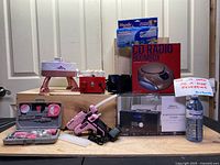 Full view showing all items from pottery wheel, weaving machine, hot glue tools, pencil sharpener, CD radio boombox, Bluetooth CD micro system, and Handy Stitch portable sewing machine box
