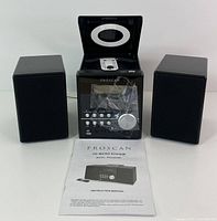 Front view of one ProScan CD micro system showing central unit with top-loading CD player open, control buttons, dial, and two speakers. Includes instruction manual.