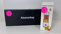 Photo of original black box with white 'Alsonerbay' label next to the product box labeled 'Portable Juicer Cup 380ml'