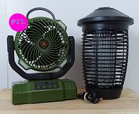 Photo of camping fan and bug zapper side by side showing overall size and design