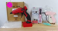 Full set including red-black glue gun, pink glue gun, glue sticks, and accessory kit with white case.
