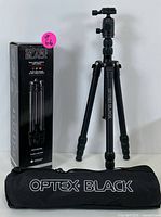 Photo of Optex Black tripod fully extended standing upright with original box and carrying bag on white background