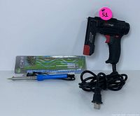 WerkTough cordless electric staple gun alongside soldering iron in original packaging