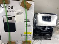 Machine in original box next to unit