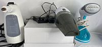 Photo showing the three appliances side by side: handheld steam cleaner, handheld vacuum, garment steamer