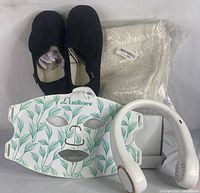 LED face mask, black slippers, neck fan, and cream cushion covers shown together