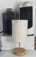 The lot showing two space heaters and one table lamp together.