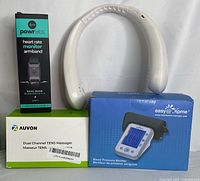 All four items shown: Heart Rate Monitor Armband in box, white Neck Fan, AUVON TENS Massager box, Easy@Home Blood Pressure Monitor box