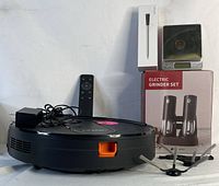 Robot vacuum with remote and charger with electric grinder set, kitchen scale and boxed meat probe.