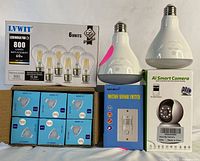 Photo showing 6-pack LVWIT 7W LED bulbs box, 6 LED bulbs in blue boxes, 2 large LED HD bulbs, Sensky motion sensor switch box, and AI Smart Camera box.