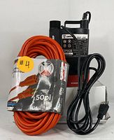 Front view of DEKO submersible water pump and coiled 50ft orange extension cord with packaging label.
