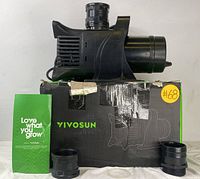 Vivosun inline duct fan on top of original box with adapters and manual placed in front.