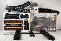 Full overview of all items including train engine, cars, tracks, remote control, box and manual