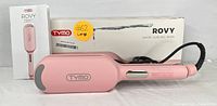 Front view of the pink TYMO Rovy hair styling tools including the straightening brush and wave curling iron, showing the product box and manual.