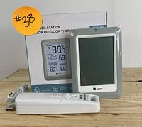 Main weather station unit with packaging and USB power cable