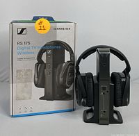Front view of the Sennheiser RS 175 wireless headphones set with charging base and original box.
