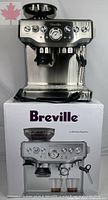 Breville Barista Express espresso machine in brushed stainless steel sitting on its retail box
