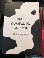 Boxed set of The Complete Far Side by Gary Larson with cow-print cover.