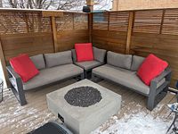 Three-piece sectional arranged on deck with cushions and pillows