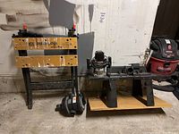 Wide view of the lot showing the Black & Decker Workmate 150 bench, Black & Decker plunge router, Hayward Vari-Flo valve, and Craftsman vacuum
