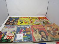 Overview of all eight vintage comic books laid flat showing front covers with colorful characters and titles.