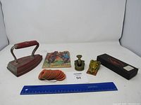 Full lot: vintage flat iron, frogs, collectible cards, story booklet, and boxed watch