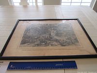 Full view of the framed vintage Union Army print on a white table with a ruler for scale.