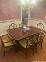 Full view of mahogany dining table with 6 matching chairs in dining room