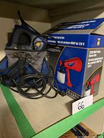 Photo of MasterCraft multi nailer in black and blue carrying case with attached power cord and the boxed 120V HVLP paint spray gun beside it.