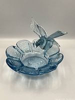 Front view of the hand blown glass bird bath with hummingbird, showing shape and detail.