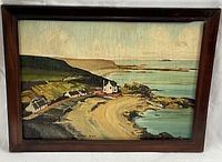 Framed oil on board painting of a coastal bay scene with houses and cliffs, titled "Canty Bay" signed by artist J. Kirkpatrick